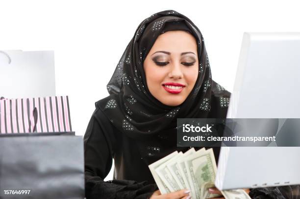 Happy Arabic Girl Shopping On The Internet Stock Photo - Download Image Now - Currency, Kuwait, Oman