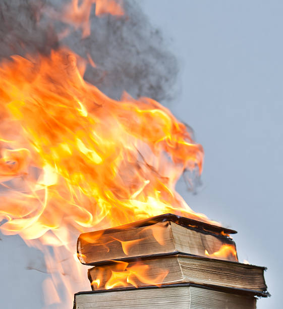 blazing hardcover books a stack of hardcover books (from the library sale, novels etc)  engulfed in flames and burning book burning stock pictures, royalty-free photos & images