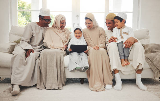 Happy family, Muslim parents or kids with tablet for elearning, Islamic info or studying in Allah or God. Grandparents, father or Arab mom with kids reading online ebook on worship prayer at home Happy family, Muslim parents or kids with tablet for elearning, Islamic info or studying in Allah or God. Grandparents, father or Arab mom with kids reading online ebook on worship prayer at home middle eastern ethnicity mature adult book reading stock pictures, royalty-free photos & images