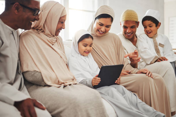 Big family, Muslim parents or happy kids with tablet for learning, Islamic info or studying in Allah or God. Grandparents, dad or Arabic mom with kids reading online ebook on worship prayer at home Big family, Muslim parents or happy kids with tablet for learning, Islamic info or studying in Allah or God. Grandparents, dad or Arabic mom with kids reading online ebook on worship prayer at home middle eastern ethnicity mature adult book reading stock pictures, royalty-free photos & images