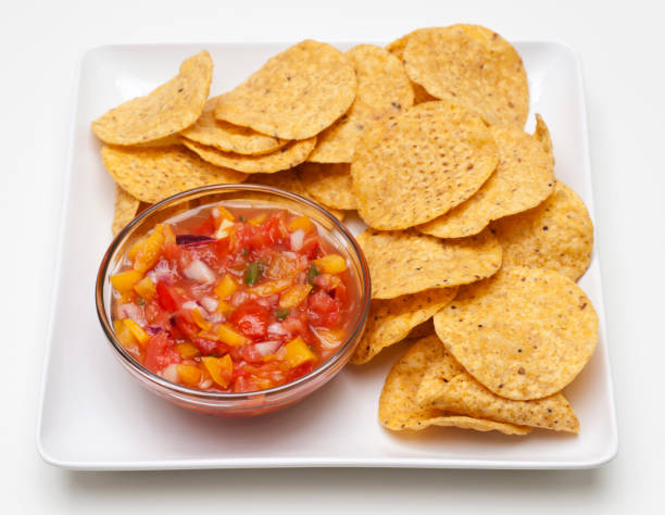 istock Round corn chips with glass bowl of salsa. 157647251