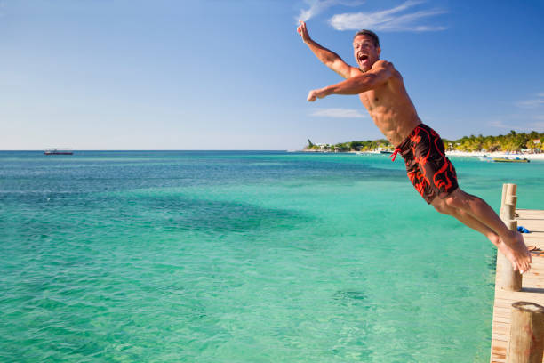 istock Man jumping off pier into sea 157647278