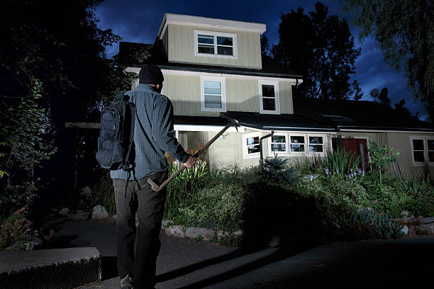 Burglar approaching a home at night