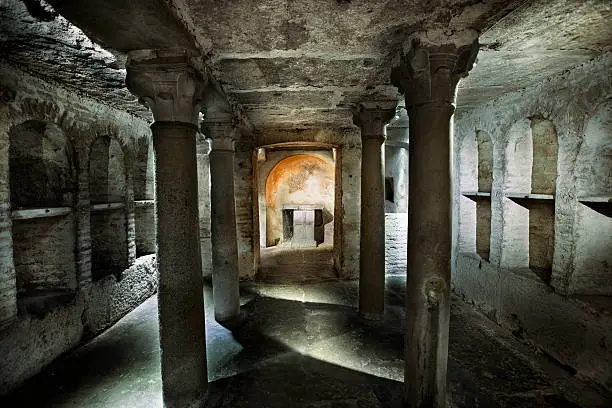 A stock photo of a tomb crypt under the Basilica of Saint Mary in Cosmedin in Rome, Italy built in the 6th century.