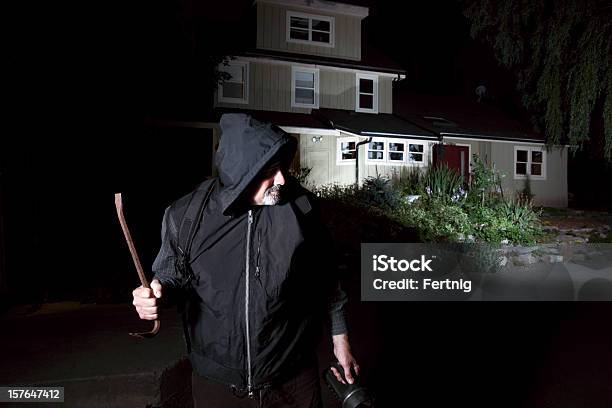 Burglar Contemplating Breakingin To A Home Stock Photo - Download Image Now - Burglary, Burglar, Dark