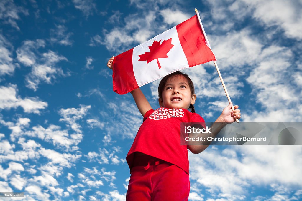 A 5-year-old smiling girl holding a Canadian flag  Canada Day Stock Photo