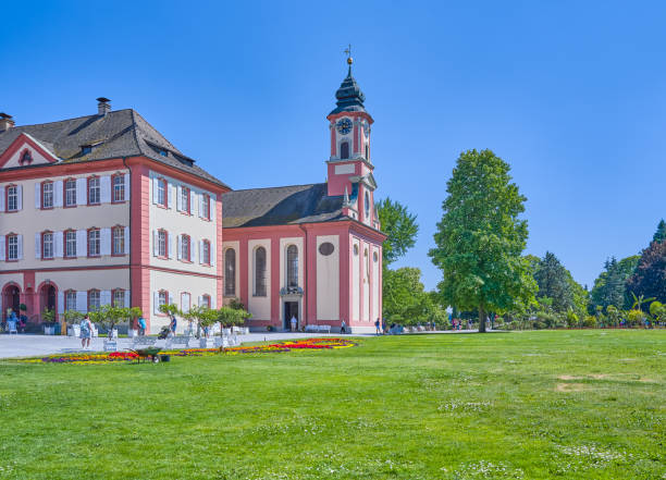 Mainau Island, Germany - June 14, 2023: View of the Baroque Palace and the St. Mary church