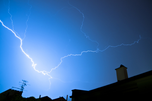 flash of lightning over housetops