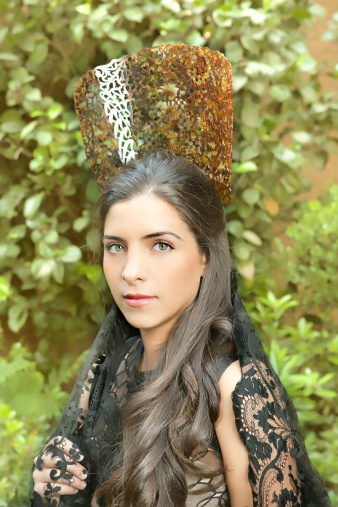 girl wearing an ornament comb and mantilla in the garden