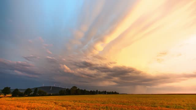 Timelapse  footage of moving clouds in the sky over  pasture landscape with  trees, for wallpaper