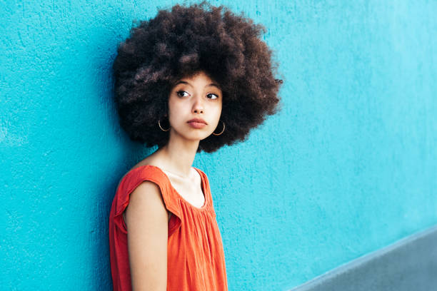 istock Pensive woman in Afro hair looking at camera 1576486708