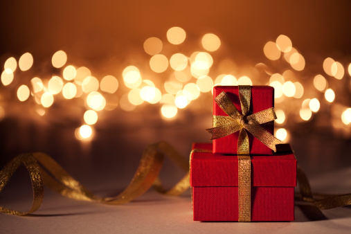 Christmas gifts with fairy light background.