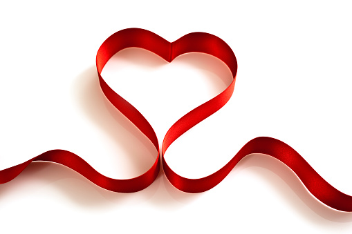 Heart shaped red ribbon isolated on white background