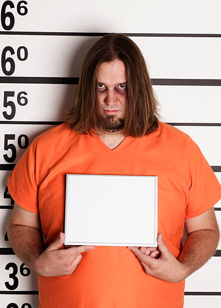 istock Mugshot of a Large Man in Prison Uniform 157648788
