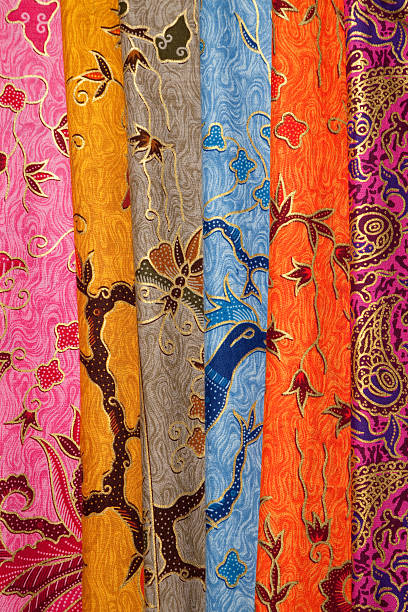 Colourful painted batik textiles at Indonesian textile market. In the social and religious lives of Indonesians textiles are very important. Printed and handpainted batik are just two of a large variety of techniques.  batik indonesia stock pictures, royalty-free photos & images