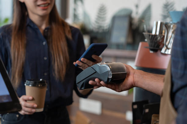 istock Woman use smartphone to scan QR code to pay in cafe restaurant with a digital payment without cash. Choose menu and order accumulate discount. E wallet, technology, pay online, credit card, bank app. 1576488821