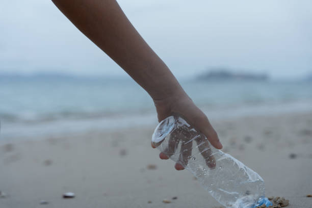 istock Save water. Volunteer pick up trash garbage at the beach and plastic bottles are difficult decompose prevent harm aquatic life. Earth, Environment, Greening planet, reduce global warming, Save world 1576489897
