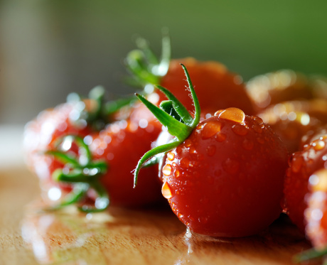 Close up of Italian cherry tomatoes with drops of water. Shallow depth of field.