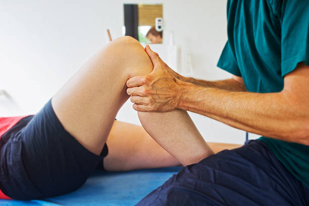 Checking a knee Testing a knee for stability of anterior cruciate ligament. XXL size image. sports physical stock pictures, royalty-free photos & images