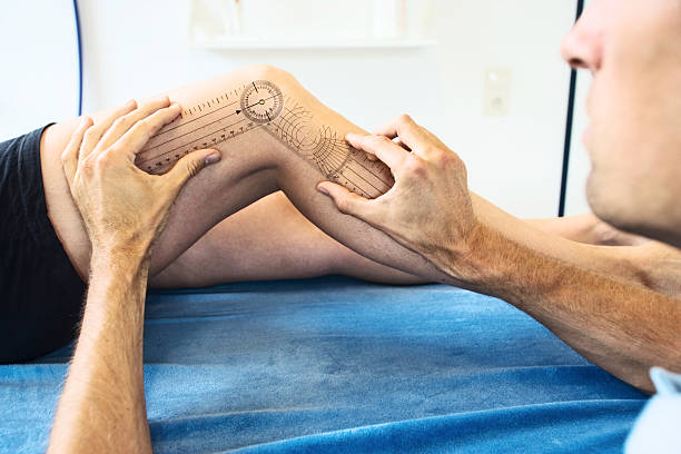 Measuring a knee joint Measuring the mobility of a knee joint. XXL size image. picture of protractor stock pictures, royalty-free photos & images
