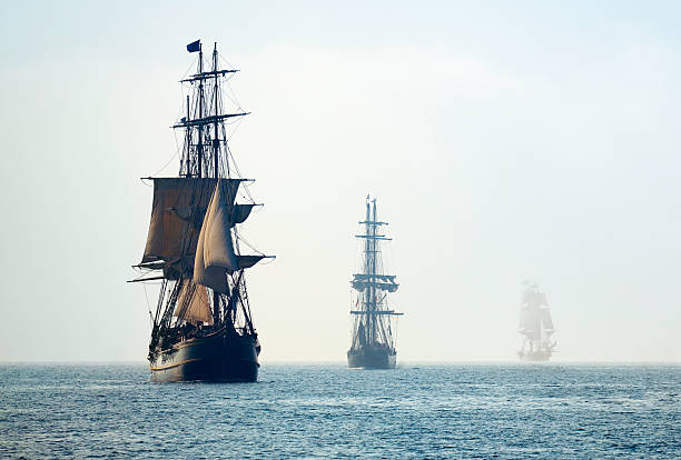 Tall Ships in the Last Mists of Morning Fog  military ship photos stock pictures, royalty-free photos & images