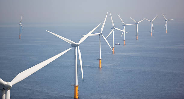 Series of wind turbines at sea stock photo