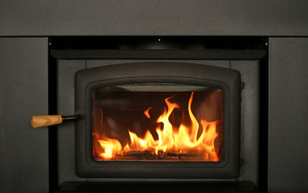 Cheery Fire Burning in Fireplace Insert stock photo