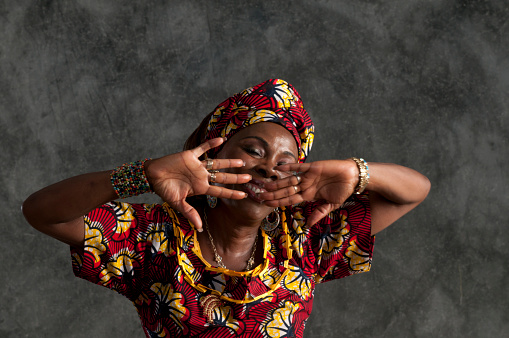 A traditional African women in dancing mode. studio lighting.