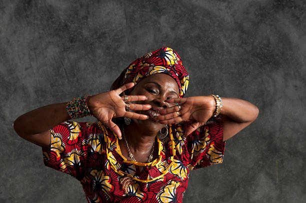 African female dancer/hands in front of face,eyes shut/close up A traditional African women in dancing mode. studio lighting. ceremonial dancing stock pictures, royalty-free photos & images