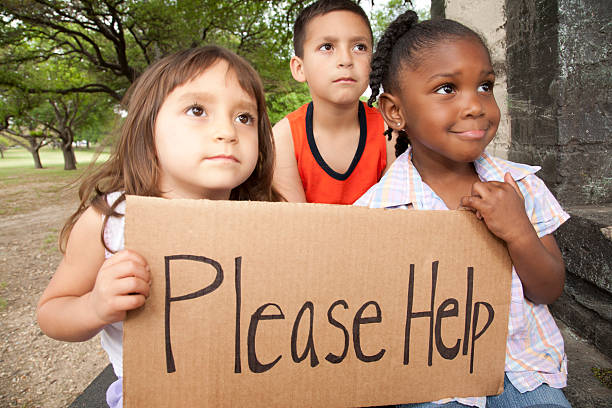Two African girls holding a sign with \