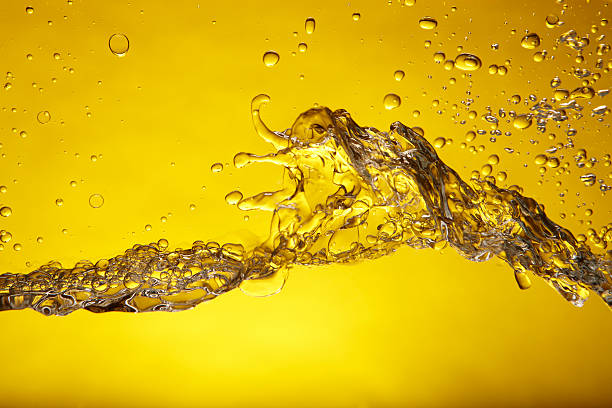 A splash of water over a yellow background Water splash caught in action. Shot on Canon EOS 1Ds mark 3 ethanol photos stock pictures, royalty-free photos & images