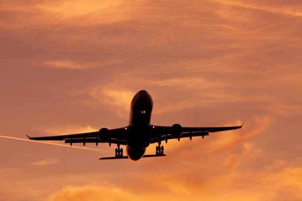 istock one airplane landing or starting at sunrise 157649706