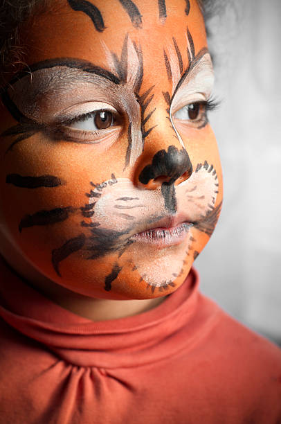 istock Child with Her Tiger Face Paint, Daydreaming 157650064
