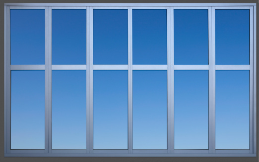 A metal office window containing a precise clipping path to separate the window frame from the wall and sky for use as a design element. Canon 5D MarkII.