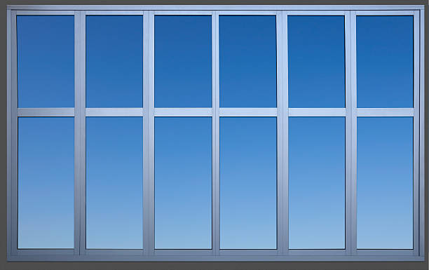 Isolated Metal Framed Paneled Office Window with Clipping Path A metal office window containing a precise clipping path to separate the window frame from the wall and sky for use as a design element. Canon 5D MarkII. window frame stock pictures, royalty-free photos & images