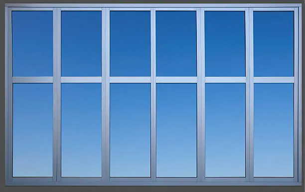 A metal office window containing a precise clipping path to separate the window frame from the wall and sky for use as a design element. Canon 5D MarkII.