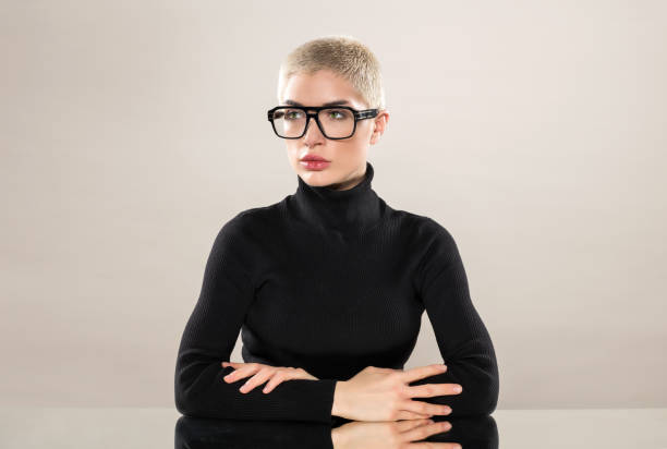 istock Short haired woman in glasses sitting in studio 1576503872