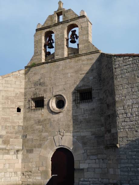 istock Antique stone bell tower standing tall against a bright blue sky 1576504580