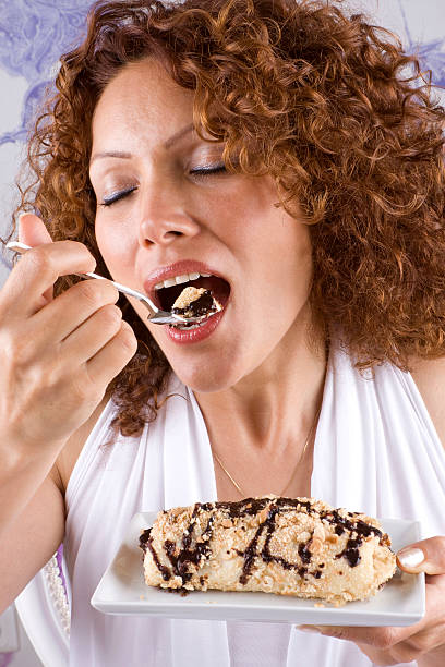 Beautiful adult woman eating dessert
