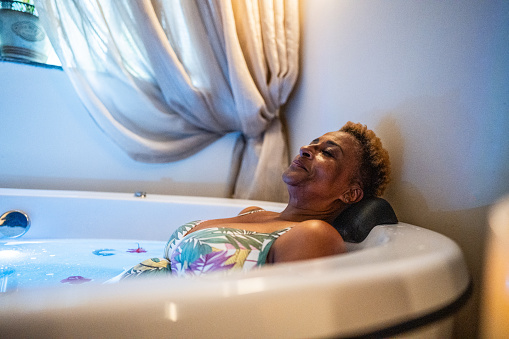 Senior woman on a bathtub at a hotel beauty spa