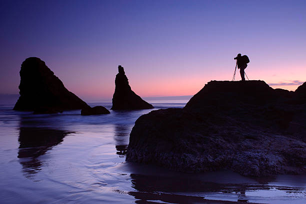 Bandon Beach Oregon during hightide with Photographer stock photo