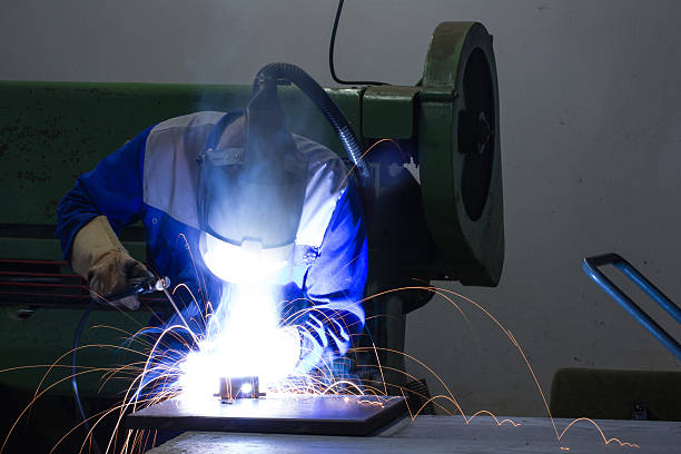 Welder with sparks (Long Exposure) Welder using TiG welding technique to join metal. FL-photography stock pictures, royalty-free photos & images