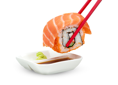 rolled sushi salmon nigiri with japanese wasabi sauce and red chopsticks isolated on white background ,include clipping path