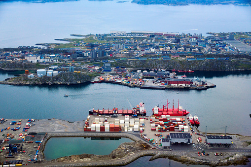 Nuuk / Godthåb, Sermersooq, Greenland: aerial view of the capital of Greenland, the city, Nuuk bay and the harbor - Nuuk (Greenlandic for headland) is Greenland's largest city with around 20,000 inhabitants. The Godthaab colony, later Nuuk, was founded in 1728 by the Danish-Norwegian priest, Hans Egede, sent by the Danish king to find the Norsemen. Hans Egede instead met the Greenlandic Inuit who had lived in the area for centuries. The colony Godthab was thus established in the settlement of Nuuk, in the area around Ippiup Qaava. Nuuk is located at the mouth of the extensive fjord system Nuup Kangerlua on the west coast of Greenland approximately 240 kilometers south of the Arctic Circle. Nuuk is the main town in Sermersooq, a Municipality the size of France in terms of area and with only 25,000 inhabitants.