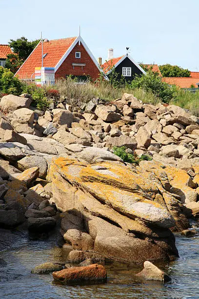 Typical Scandinavian, Danish red house off the skerries coast of Bornholm Island, Svaneke,  Denmark