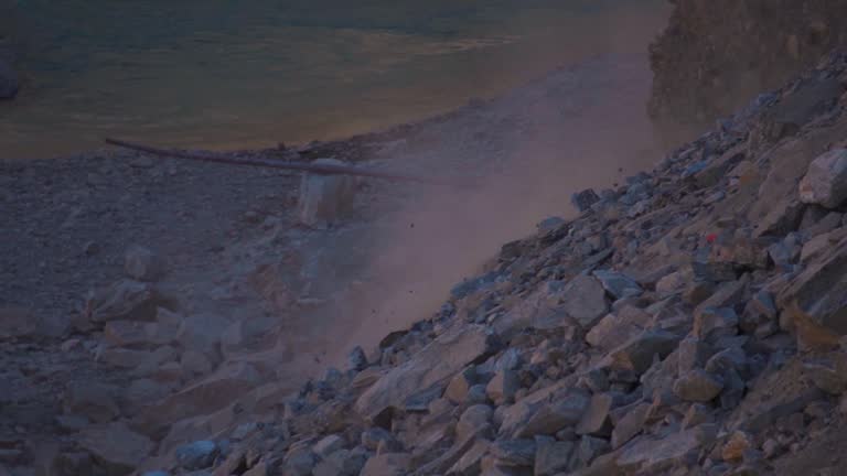 Slow motion shot of Rocks falling from mountain due to landslide in Manali, Himachal Pradesh, India. Natural disaster in mountains during monsoon. Calamity in the Himalayas.