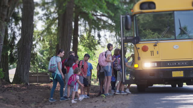 Large group of students boarding school bus