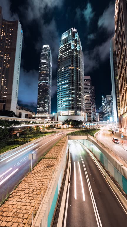 Time lapse of car traffic transportation on road, pedestrian people walk on street in financial business office district, Hong Kong central. Asia transport city night life, landmark building cityscape