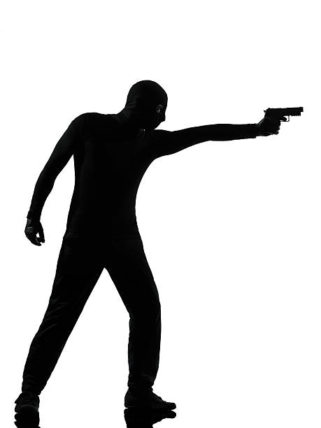 istock thief criminal terrorist aiming gun man 157662153
