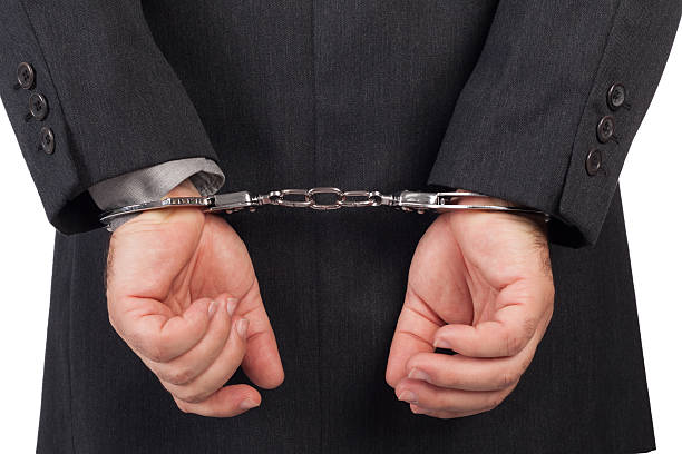 istock business man with a black suit in handcuffs 157663931